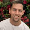 pexels-photo-2770600-2770600 Portrait of a smiling man in front of vibrant flowers in Chicago.